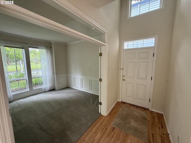 1000 NE Park Edge Cir, Hillsboro, OR 97124 - entryway with plenty of natural light, light wood finished floors, a wainscoted wall, a decorative wall, and crown molding