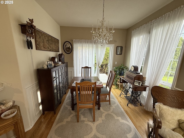 dining space featuring an inviting chandelier and light wood-style flooring