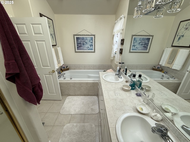 bathroom featuring double vanity, tile patterned flooring, a sink, and a bath