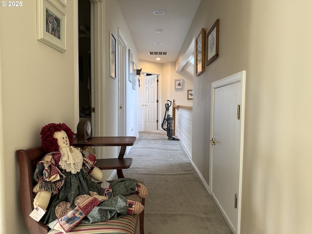 hallway featuring carpet floors, recessed lighting, visible vents, and baseboards