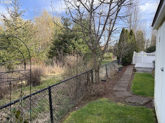 view of yard with fence and a wooden deck