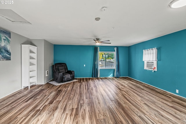 unfurnished room with cooling unit, wood finished floors, and ceiling fan