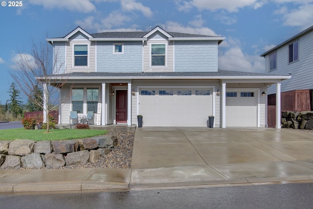 traditional home with covered porch, driveway, and an attached garage