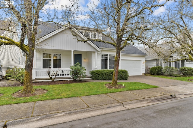 view of front facade featuring a garage, roof with shingles, a porch, and driveway