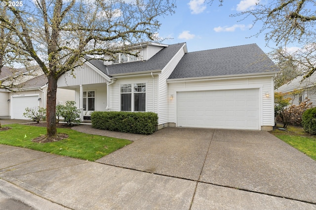 view of front of property featuring a garage, roof with shingles, and concrete driveway