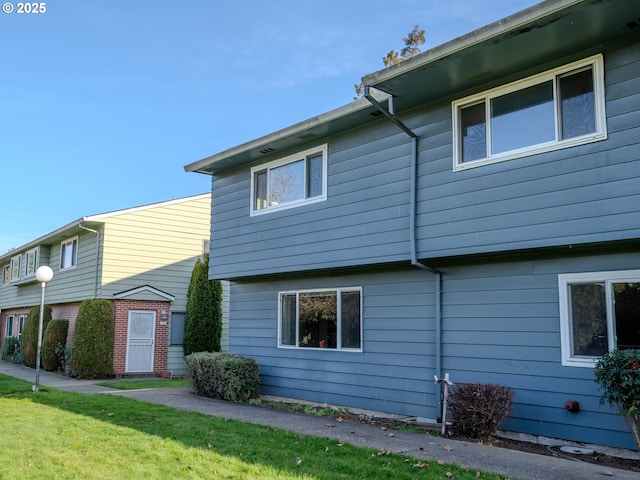 view of side of property with a lawn