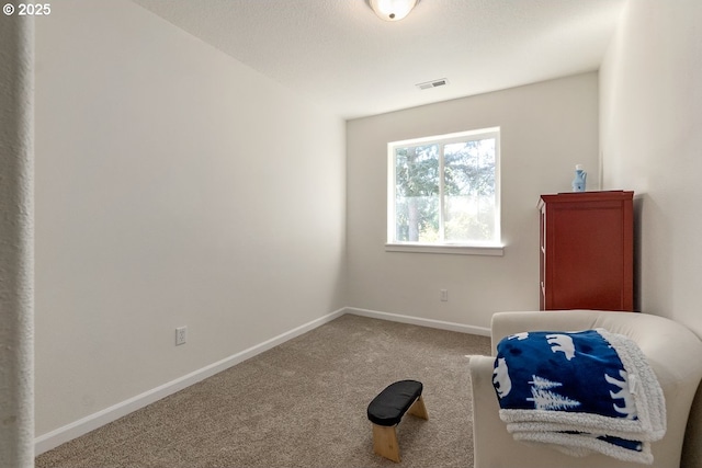 interior space with baseboards, visible vents, and carpet flooring