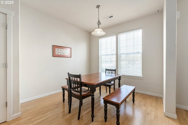 dining area with visible vents, baseboards, and light wood-style floors