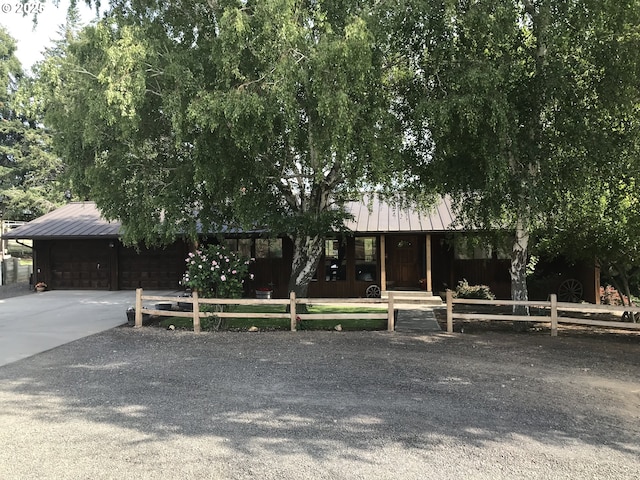 43497 Shetland Ct, Pendleton, OR 97801 - obstructed view of property with metal roof, a garage, and concrete driveway