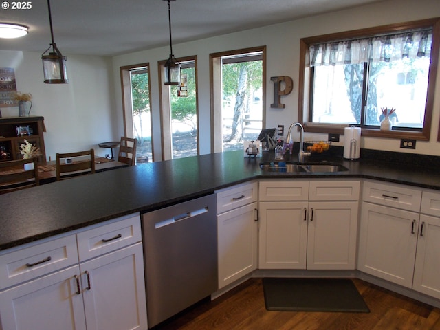 43497 Shetland Ct, Pendleton, OR 97801 - kitchen featuring stainless steel dishwasher, a sink, white cabinets, and dark wood-style floors