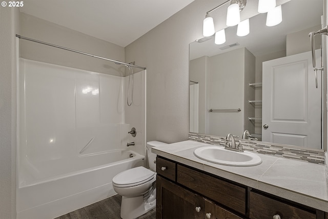 bathroom with visible vents, toilet, shower / tub combination, wood finished floors, and vanity