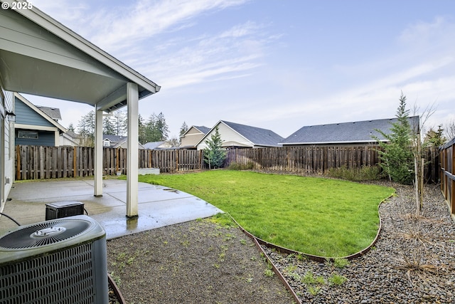 view of yard with a patio area, a fenced backyard, and central AC