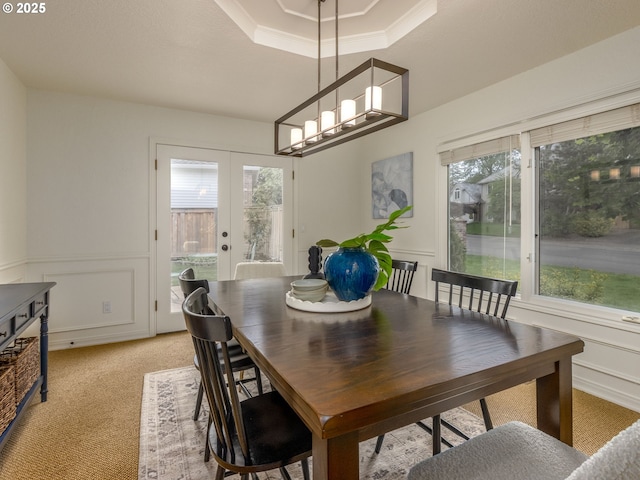 14066 Edenberry Dr, Lake Oswego, OR 97035 - dining space featuring a decorative wall, french doors, plenty of natural light, a tray ceiling, and light carpet