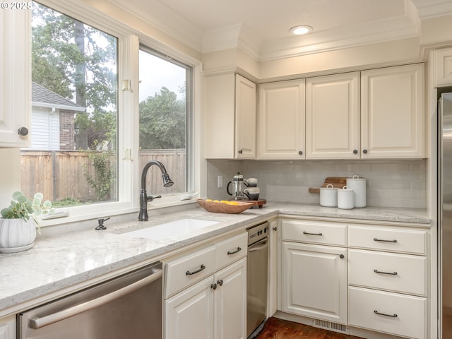 14066 Edenberry Dr, Lake Oswego, OR 97035 - kitchen featuring stainless steel dishwasher, a sink, white cabinetry, backsplash, and ornamental molding