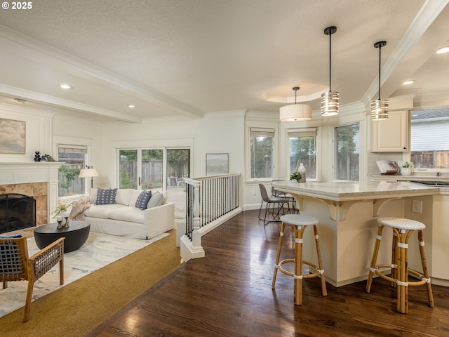14066 Edenberry Dr, Lake Oswego, OR 97035 - kitchen with dark wood-style floors, a breakfast bar, pendant lighting, open floor plan, and crown molding