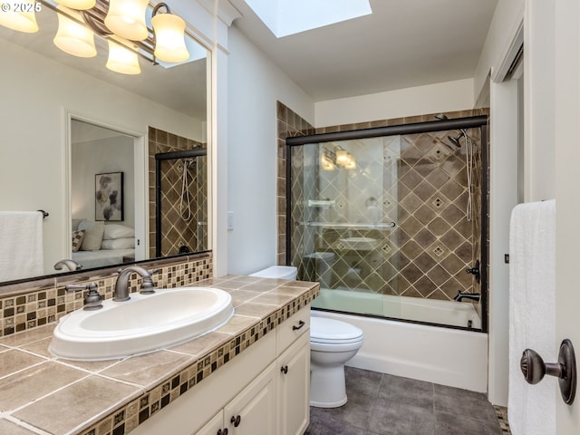 14066 Edenberry Dr, Lake Oswego, OR 97035 - bathroom with toilet, vanity, a skylight, and shower / bath combination with glass door