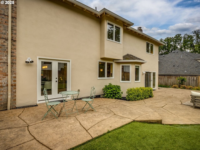 14066 Edenberry Dr, Lake Oswego, OR 97035 - back of property with french doors, stucco siding, and a patio