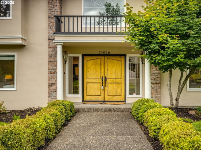 14066 Edenberry Dr, Lake Oswego, OR 97035 - doorway to property with a balcony and stucco siding