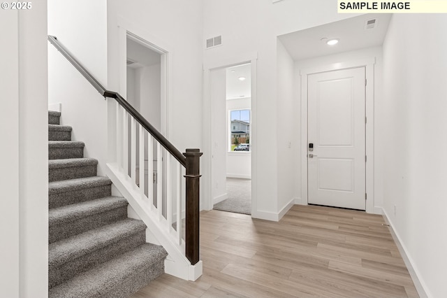 2149 NE Singer Ln, Estacada, OR 97023 - foyer entrance with baseboards, visible vents, stairway, and light wood-style floors