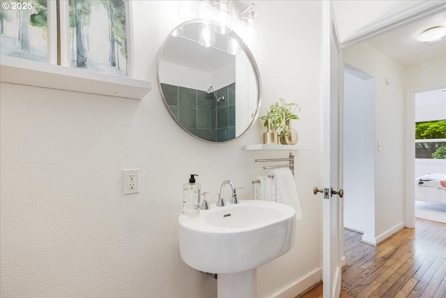 5310 NE 10th Ave, Portland, OR 97211 - bathroom with baseboards, a sink, and hardwood / wood-style floors