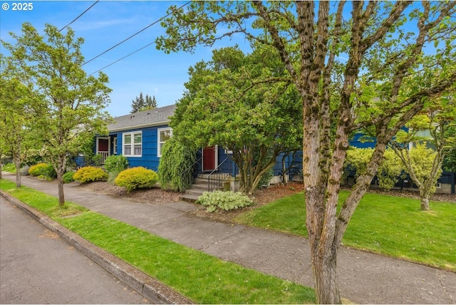 5310 NE 10th Ave, Portland, OR 97211 - view of front facade featuring a shingled roof and a front lawn