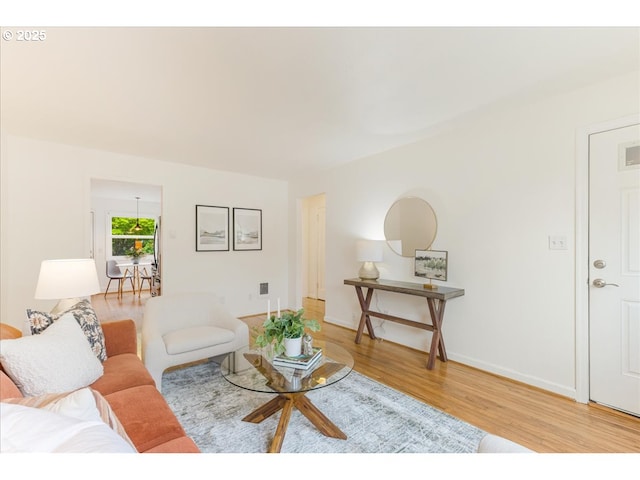 living room with baseboards and wood finished floors