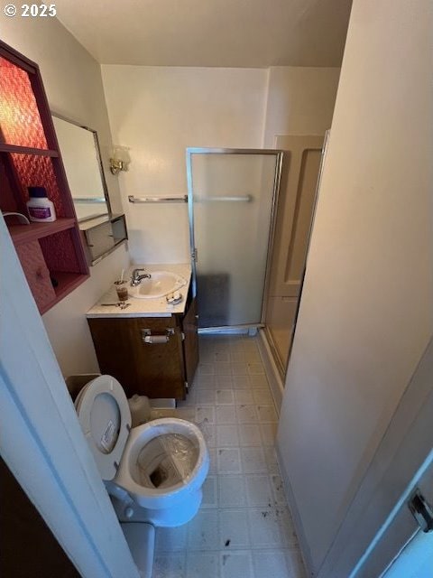 full bathroom with vanity, tile patterned floors, a stall shower, and toilet