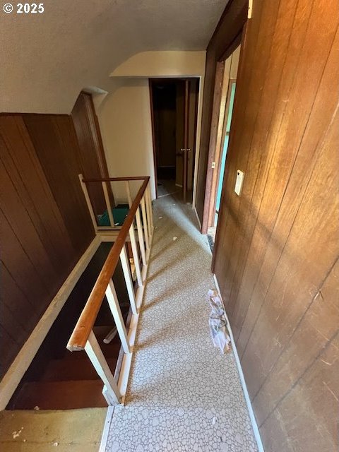 stairs featuring wooden walls