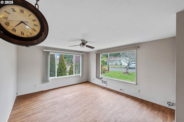 empty room featuring ceiling fan and light wood-type flooring