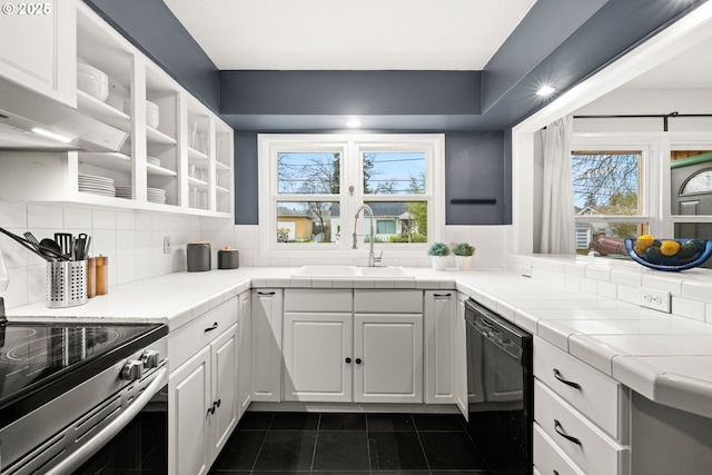 kitchen featuring a sink, backsplash, dishwasher, white cabinets, and open shelves