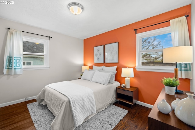 bedroom with wood finished floors and baseboards