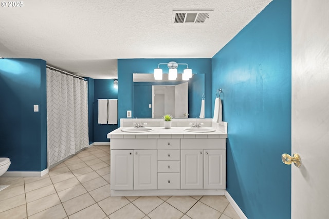 bathroom featuring tile patterned floors, visible vents, toilet, and a sink