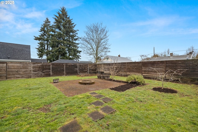 view of yard with a fire pit and a fenced backyard