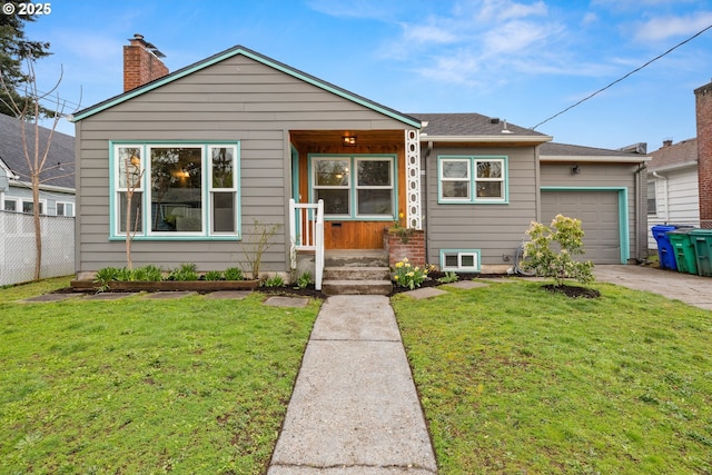 view of front of property with a front lawn, fence, a chimney, driveway, and an attached garage