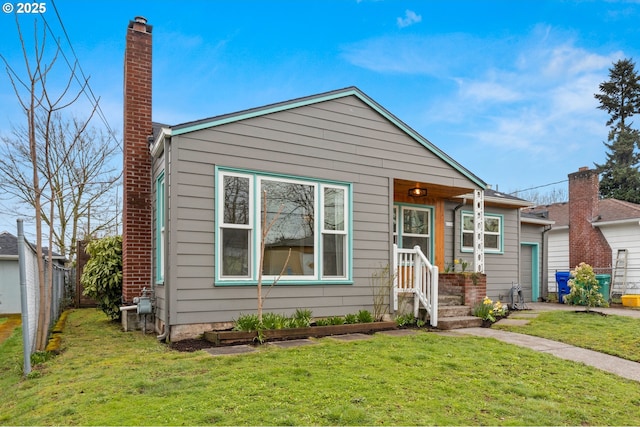 view of front of house featuring a front yard, fence, and a chimney