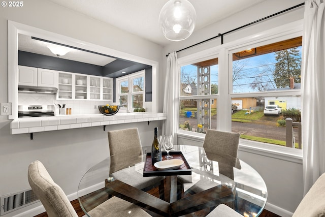 dining room with wood finished floors and baseboards