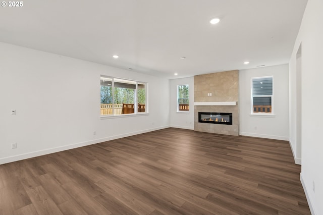 11016 NE 131st Ct, Vancouver, WA 98682 - unfurnished living room featuring recessed lighting, dark wood-type flooring, a tiled fireplace, and baseboards