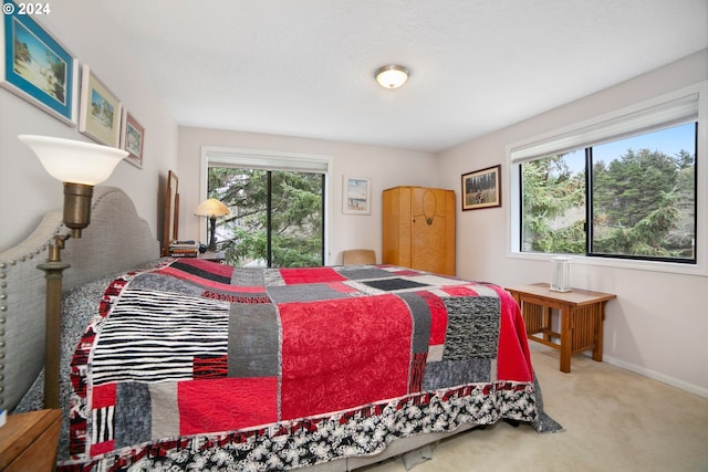 carpeted bedroom with baseboards and multiple windows