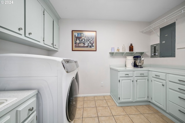 laundry area featuring washing machine and clothes dryer, baseboards, electric panel, light tile patterned floors, and cabinet space