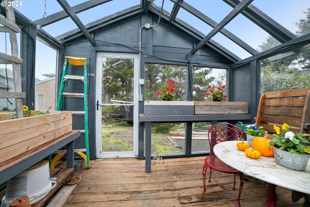 sunroom with lofted ceiling with skylight