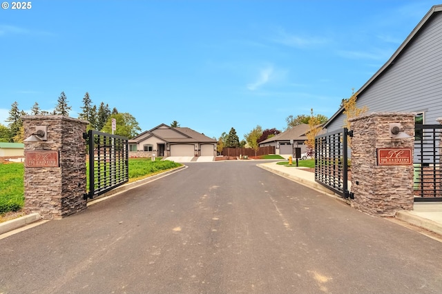 4908 NE 132nd Cir, Vancouver, WA 98686 - view of asphalt road with curbs, a gate, and a residential view