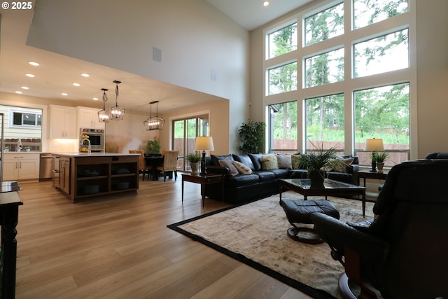 4908 NE 132nd Cir, Vancouver, WA 98686 - living room featuring high vaulted ceiling, light wood-style floors, recessed lighting, and a chandelier