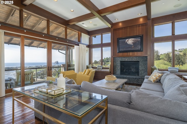 7850 Brooten Mountain Loop, Pacific City, OR 97135 - living room with dark wood-style floors, a high end fireplace, beam ceiling, and a towering ceiling