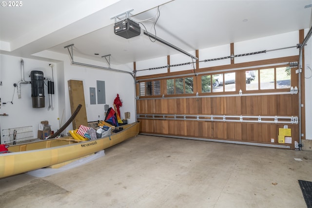7850 Brooten Mountain Loop, Pacific City, OR 97135 - garage with a garage door opener, electric panel, and a central vacuum unit