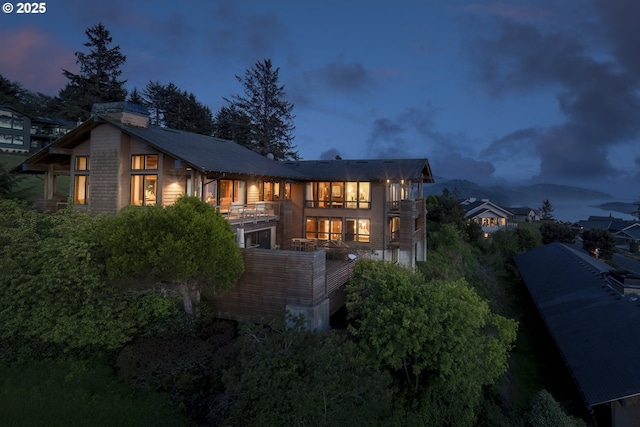 7850 Brooten Mountain Loop, Pacific City, OR 97135 - back of house with a balcony and a chimney
