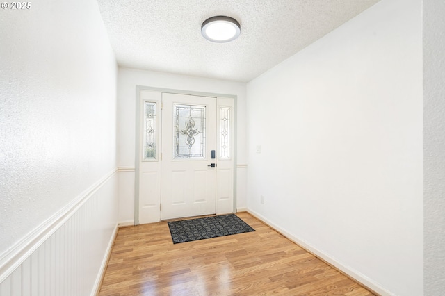12712 NE 8th Pl, Vancouver, WA 98684 - foyer featuring baseboards, a textured ceiling, and light wood finished floors