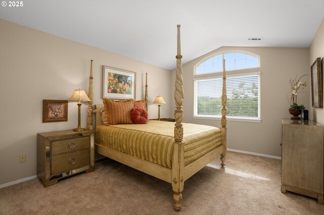 bedroom with carpet floors, baseboards, vaulted ceiling, and visible vents