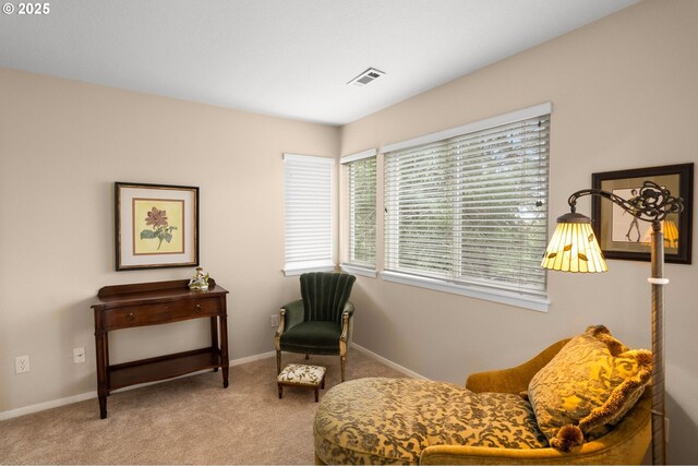 sitting room with carpet floors, baseboards, and visible vents