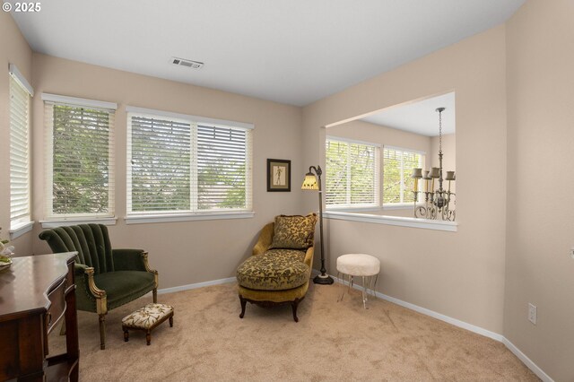 living area with carpet floors, baseboards, and visible vents