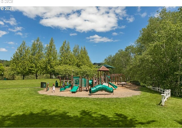 community jungle gym featuring a yard